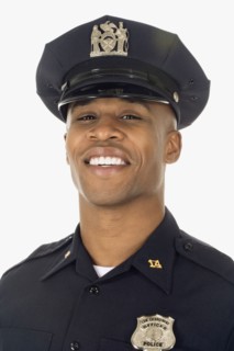 Studio shot of African male police officer smiling
