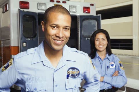 Portrait of paramedics in front of ambulance