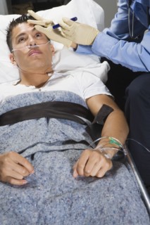 Man in being examined by paramedic