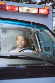 African male paramedic driving ambulance