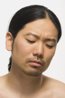 Asian man looking down
