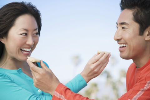 Asian couple feeding each other