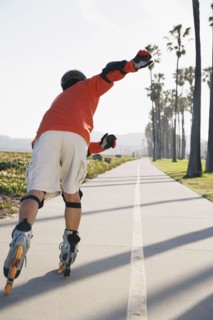 Asian man rollerblading