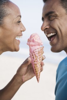 Multi-ethnic couple eating ice cream cone