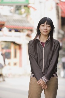 Chinese woman smiling on urban street