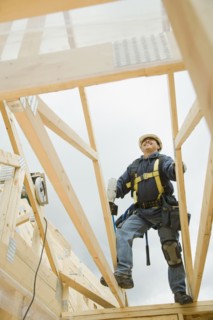 Hispanic construction worker building house