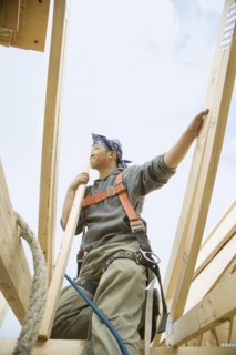 Hispanic construction worker building house