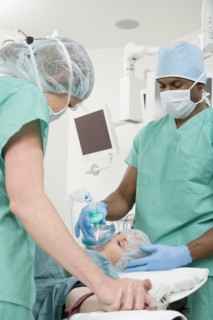 Doctors with patient in operating room
