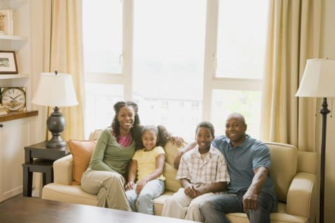 African American family sitting in living room
