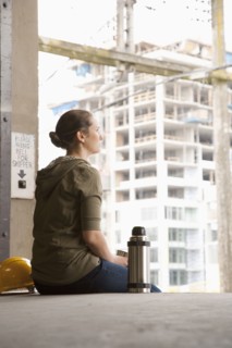 Mixed race woman taking a break on warehouse loading dock