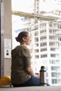 Mixed race woman taking a break on warehouse loading dock