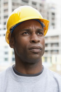 Black construction worker frowning