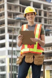 Mixed race woman in hard-hat on construction site