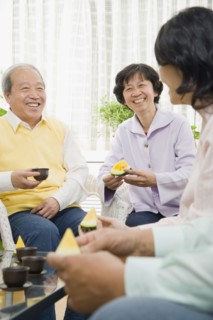 Chinese family enjoying fruit and tea