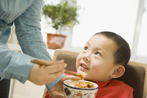 Chinese grandmother feeding son