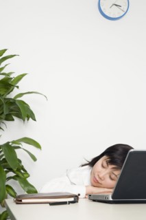 Chinese businesswoman sleeping at desk