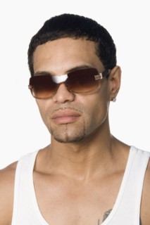 Hispanic man wearing sunglasses and looking serious