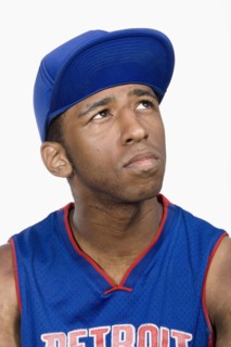 Hispanic man in baseball cap looking up