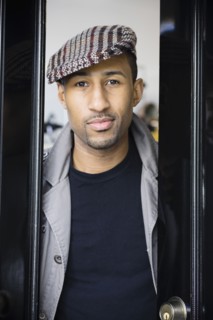 African American man wearing coat and cap