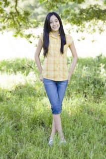 Hispanic girl standing in field