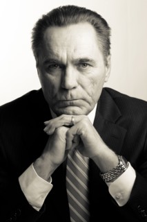 Serious Caucasian businessman with hands on chin