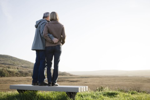 Caucasian couple hugging on beach