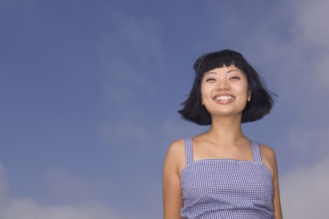 Portrait of Asian woman under blue sky