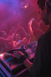 Hispanic dj playing at nightclub