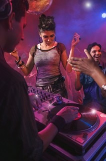 Hispanic dj playing at nightclub