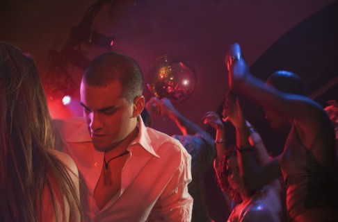 Multi-ethnic people dancing at nightclub