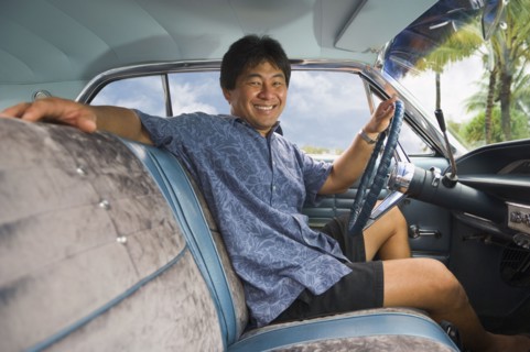 Asian man sitting in car