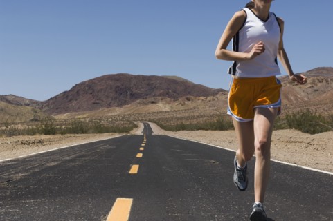 Mixed Race female runner on road