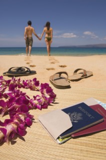 Couple walking away from passport and sandals on beach