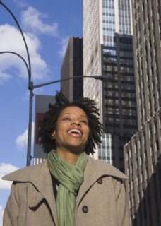 African American woman laughing in urban scene