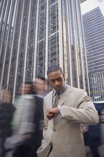 African American businessman checking watch