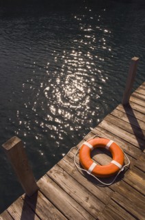Round life preserver on wooden dock