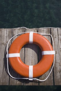 Round life preserver on wooden dock