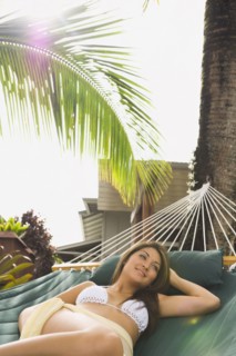 Asian woman laying in hammock