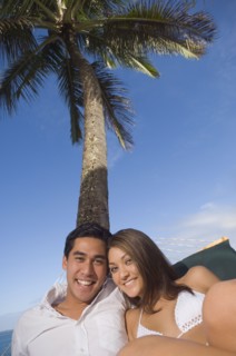 Multi-ethnic couple laying in hammock