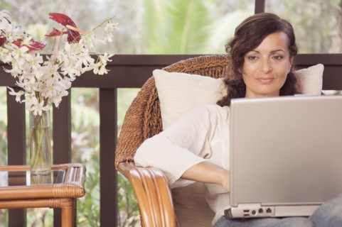 Mature woman typing on laptop