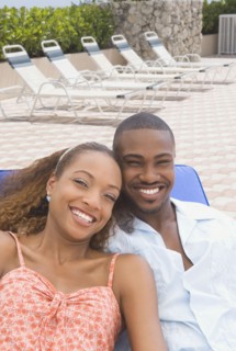 African American couple laying on lounge chair