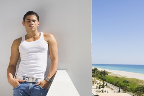 Hispanic man leaning on balcony wall