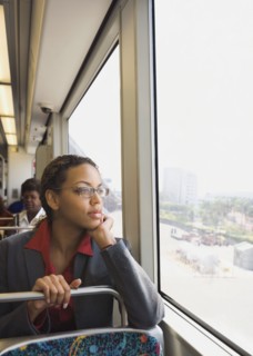 African businesswoman riding on train