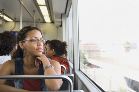African woman riding on train