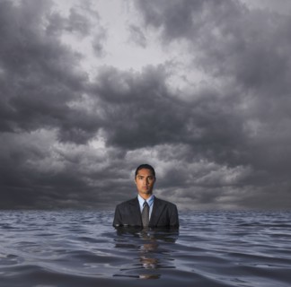 Hispanic businessman standing in water