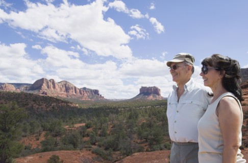 Multi-ethnic senior couple looking at desert landscape