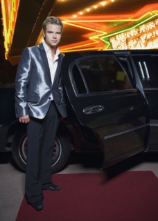 German man standing by limousine outside nightclub