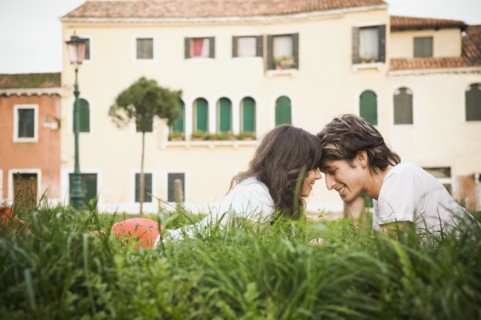 Italian couple laying in grass relaxing
