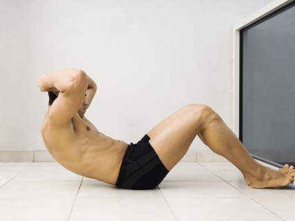 Hispanic man doing sit ups