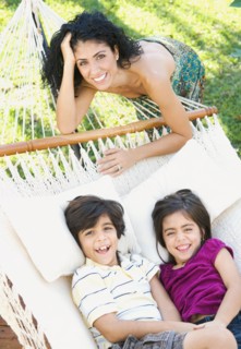 Mother and children relaxing in hammock